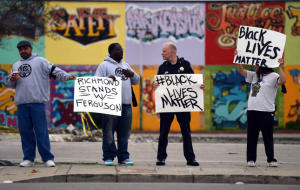 Richmond police Chief Chris Magnus chats with Randy Joseph, of Berkeley, as they stand with William McCoy, of Sacramento and with the RYSE Youth Center